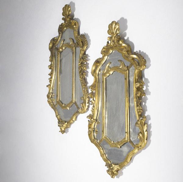 Appraisal: CONTINENTAL GILDED WALL MIRRORS Pair in elaborate frames with shell