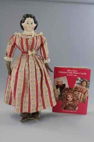 Appraisal: GREINER EARLY PAPIER-MACHE HEAD DOLL Papier-mache shoulder head doll with