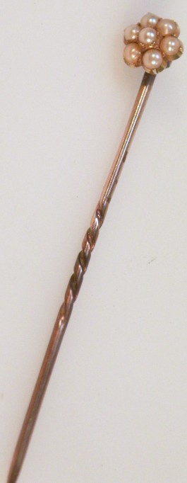 Appraisal: A stickpin with seed pearl floral head and shaped stem