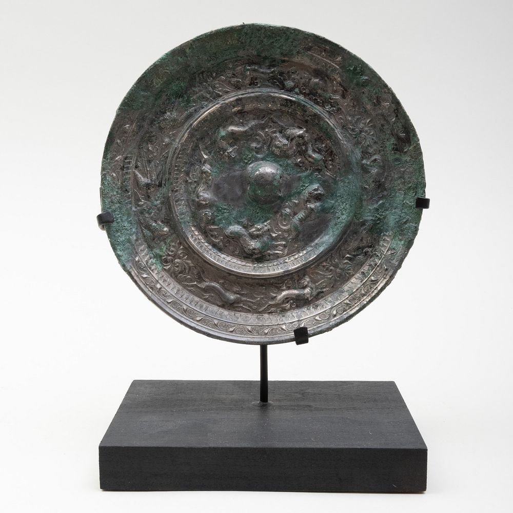 Appraisal: Chinese Silvered Bronze Mirror Decorated with beasts chasing each other's