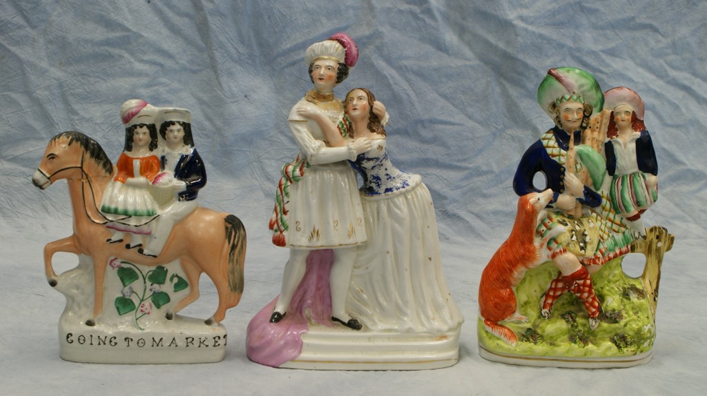 Appraisal: Staffordshire figurines Bagpiper and Boy with Dog glaze flakes Going