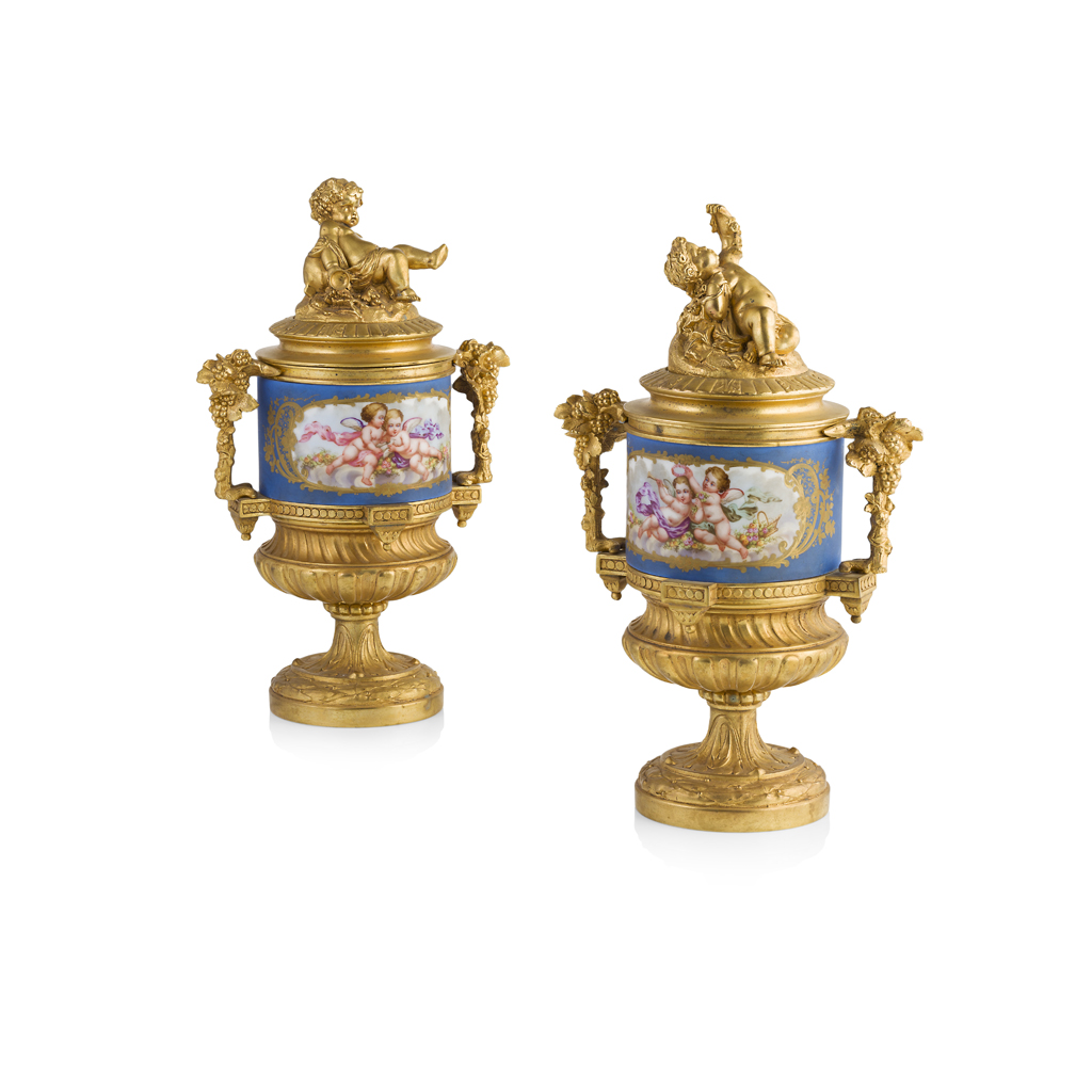 Appraisal: PAIR OF FRENCH PORCELAIN AND GILT BRONZE COVERED URNS TH