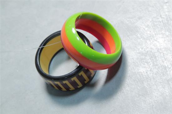 Appraisal: TWO BAKELITE BRACELETS One laminated tri-color ''w One inlaid geometric