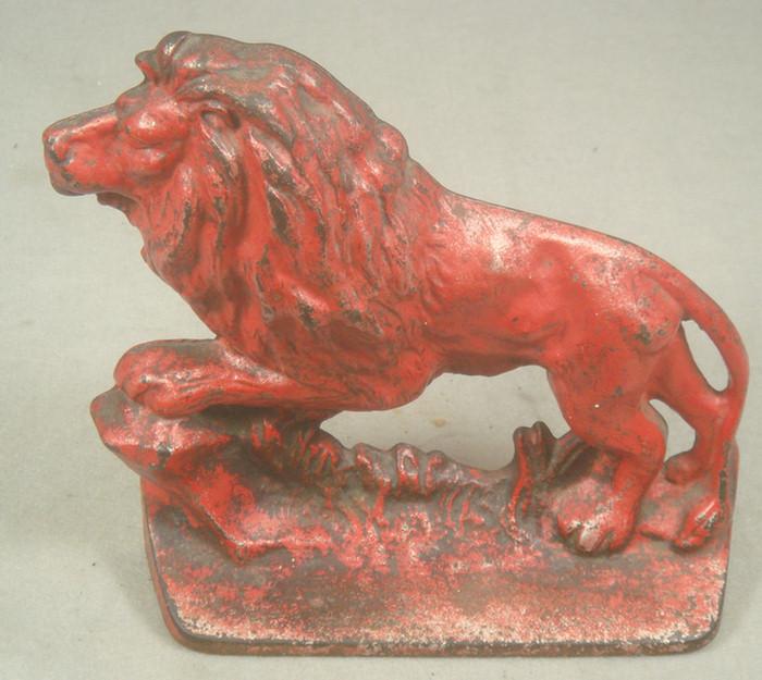 Appraisal: Cast iron doorstop red lion on red grassy base overall