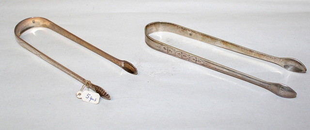 Appraisal: A PAIR OF GEORGE III SILVER SUGAR TONGS with bright