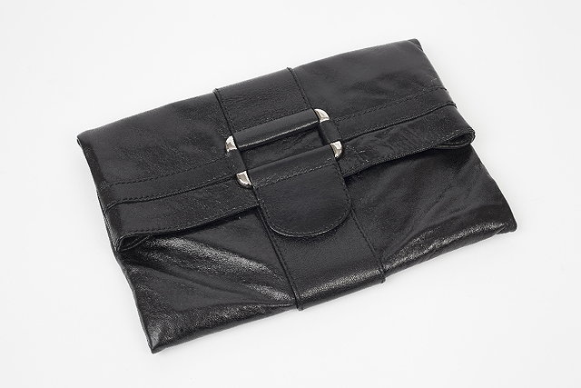 Appraisal: A high-shine black Alexander McQueen clutch bag with buckle detail