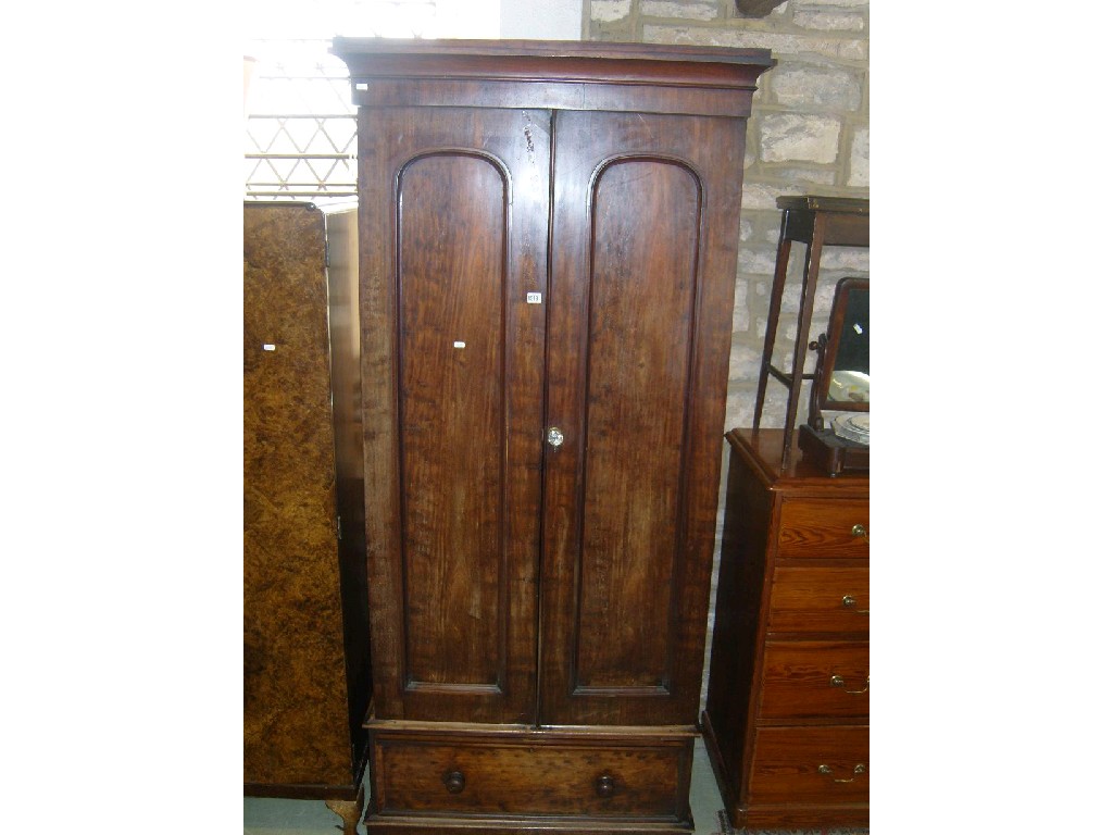 Appraisal: A Victorian mahogany wardrobe enclosed by -panelled doors above single