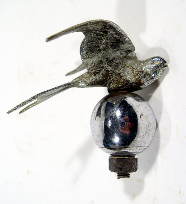 Appraisal: Chrome plated bird design car mascot on a globular base