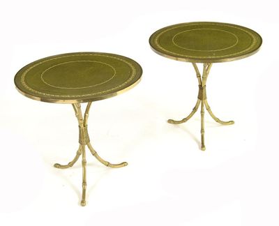 Appraisal: A pair of circular leather topped occasional tables on brass