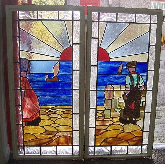 Appraisal: A pair of Dutch stained glass panels depicting a boy