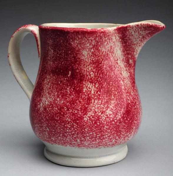 Appraisal: th Century Red Spatterware Creamer Retains original blue-petal flower with