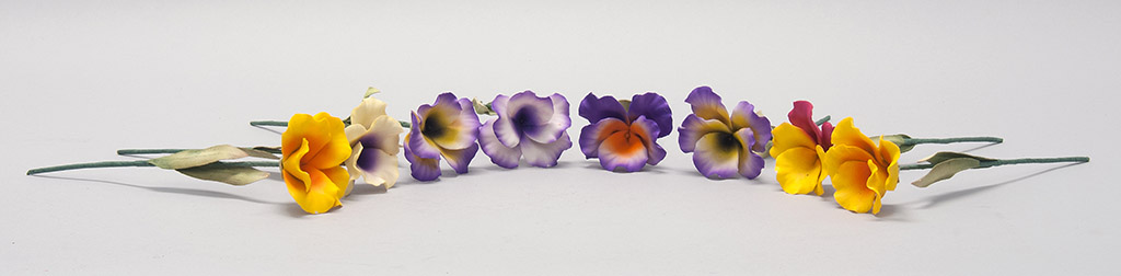 Appraisal: EIGHT PORCELAIN PANSIES in yellow and purple Approximate diameters of