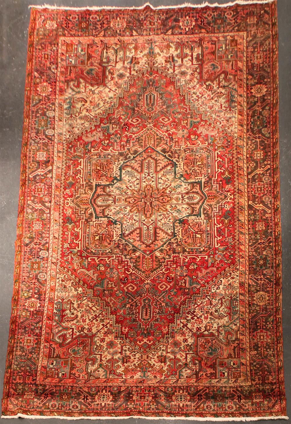 Appraisal: PAKISTANI HERIZ WOOL RUG rust pinks reds dark brown taupe