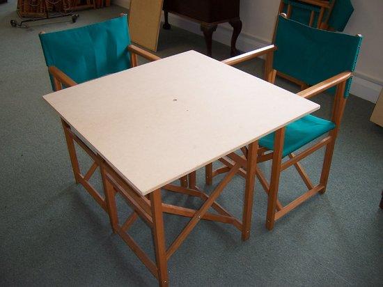 Appraisal: A folding table and two folding chairs with canvas seats