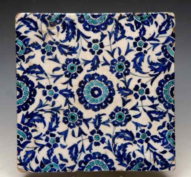 Appraisal: A PERSIAN SQUARE TILE with trailing turquoise and cobalt blue