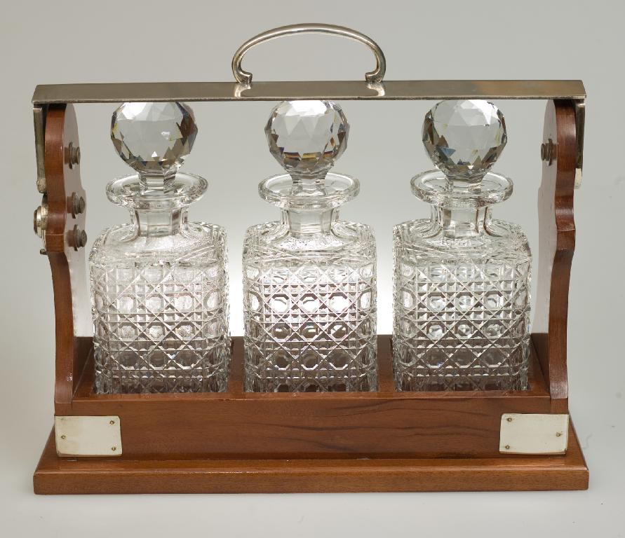 Appraisal: SILVER PLATE-MOUNTED MAHOGANY TANTALUS fitted with three square decanters cm