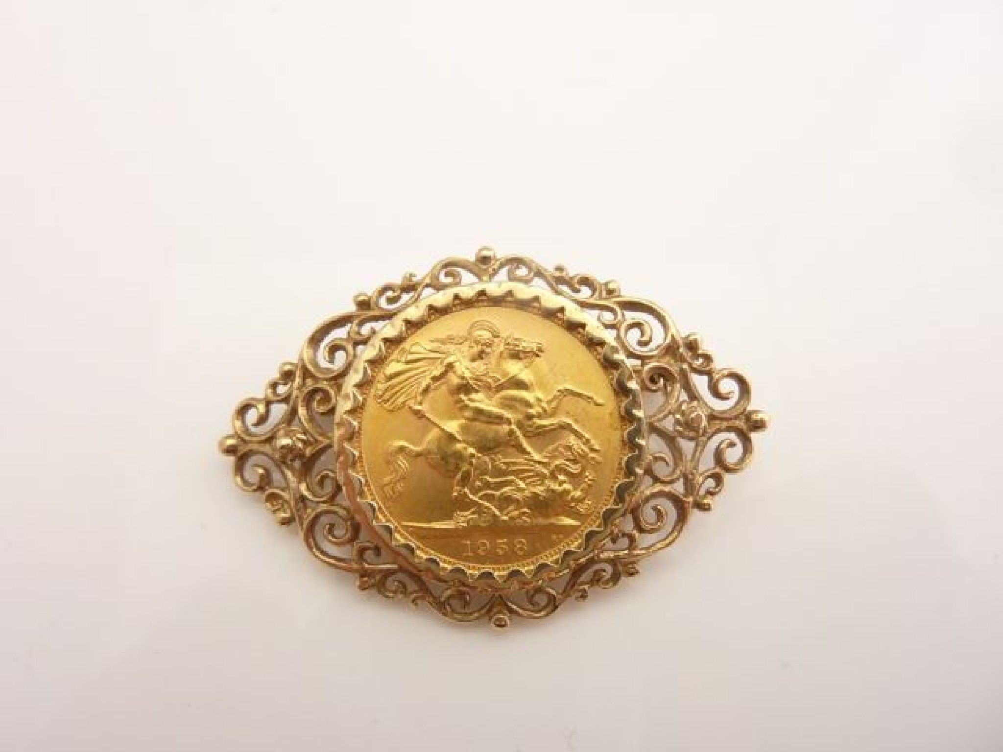 Appraisal: A sovereign coin brooch mounted with an openworked ct gold