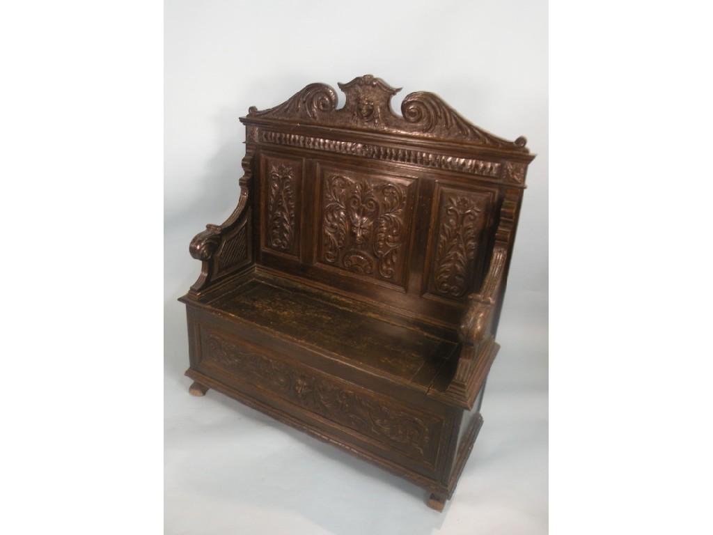 Appraisal: A stained Victorian oak settle carved with masks scrolls and