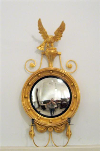 Appraisal: Regency style giltwood girandole wall mirror The circular mirror plate