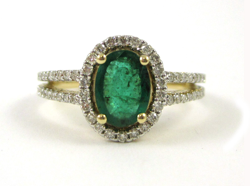 Appraisal: FOURTEEN KARAT GOLD EMERALD AND DIAMOND RING round-cut diamonds surround