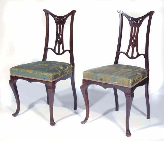 Appraisal: A SET OF FOUR EDWARDIAN MAHOGANY DINING CHAIRS with carved