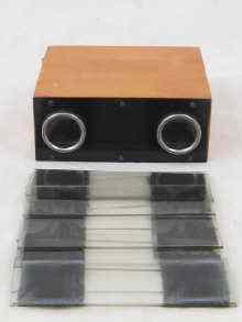 Appraisal: A French pocket stereoscopic viewer with about fourteen glass slides