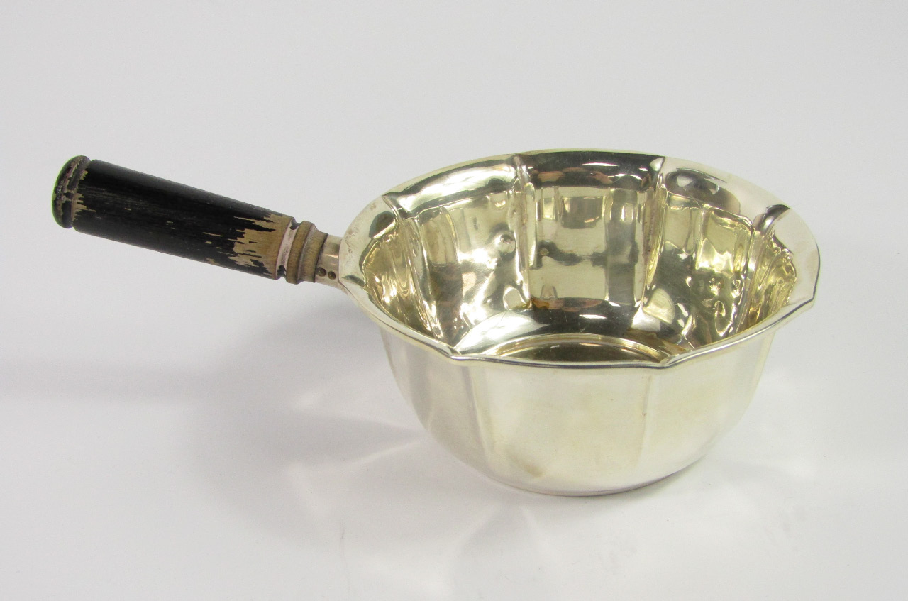 Appraisal: A Danish silver fluted saucepan with a turned wooden handle