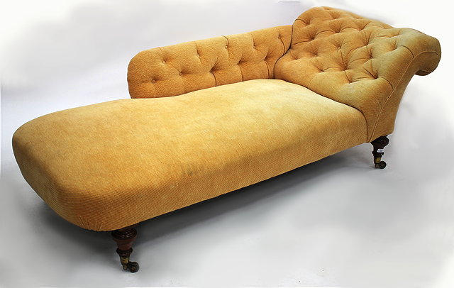 Appraisal: A VICTORIAN CHAISE LOUNGUE with later button back upholstery turned