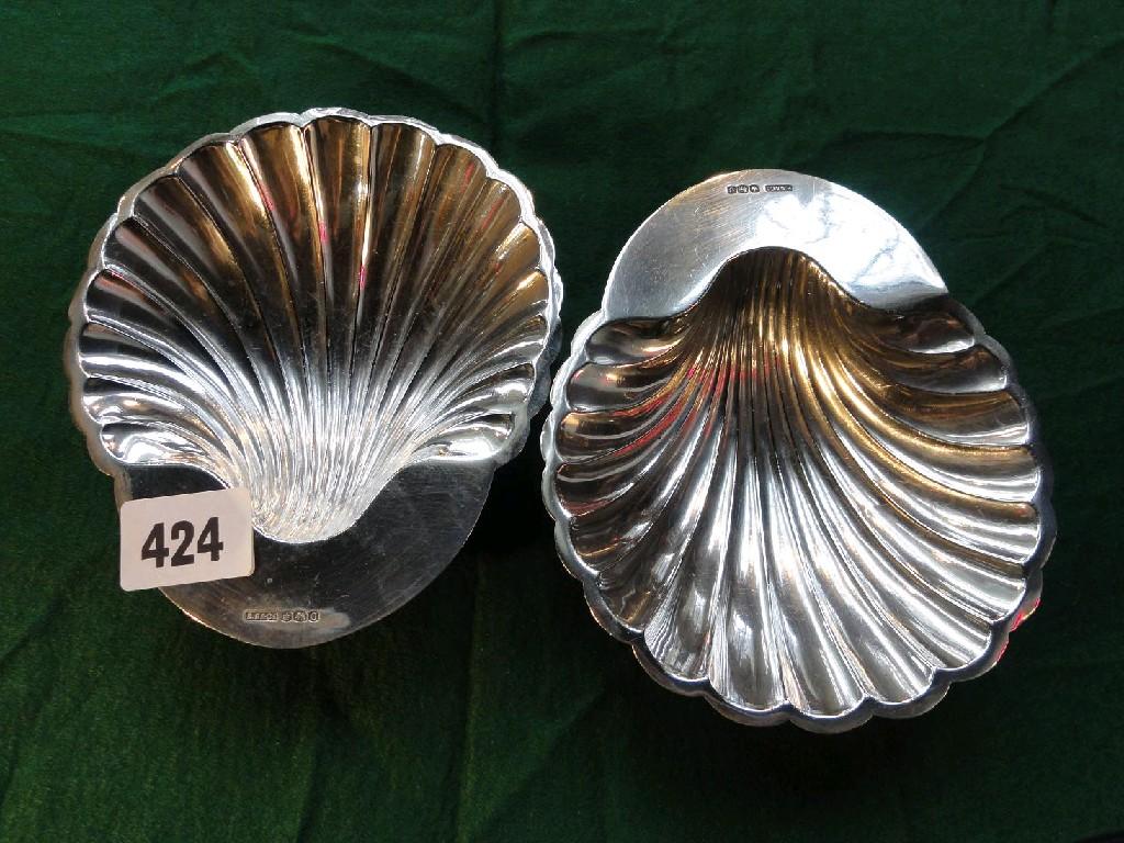 Appraisal: A pair of open silver scallop shaped ashtrays on bun