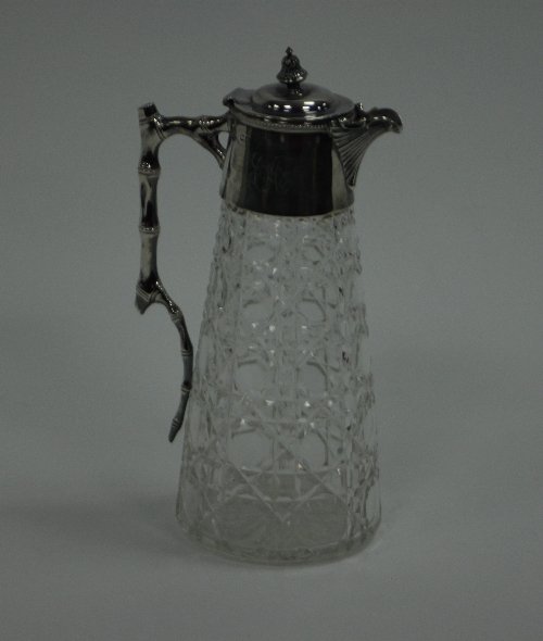 Appraisal: A cut glass claret jug with silver mounts and handles