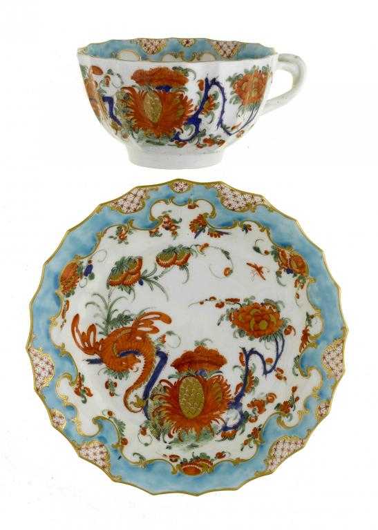 Appraisal: A WORCESTER FLUTED TEACUP AND SAUCER attractively painted in brilliant