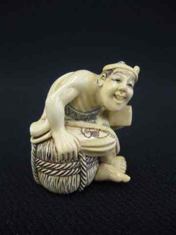 Appraisal: Carved Ivory Netsuke of a Man seated on a rice