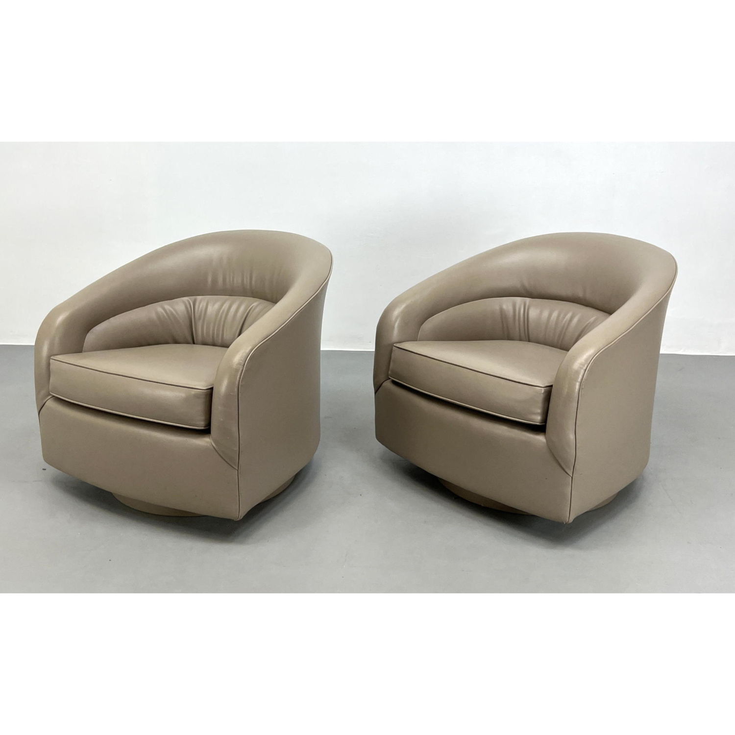 Appraisal: Pr Beige Upholstered Swivel Lounge Chairs Barrel Back Vinyl Modernist