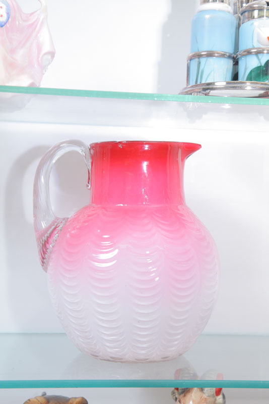 Appraisal: ART GLASS PITCHER Pink to white in Lincoln drape pattern