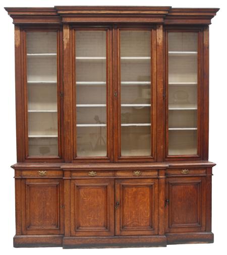 Appraisal: A th century oak breakfront bookcase the projected moulded cornice