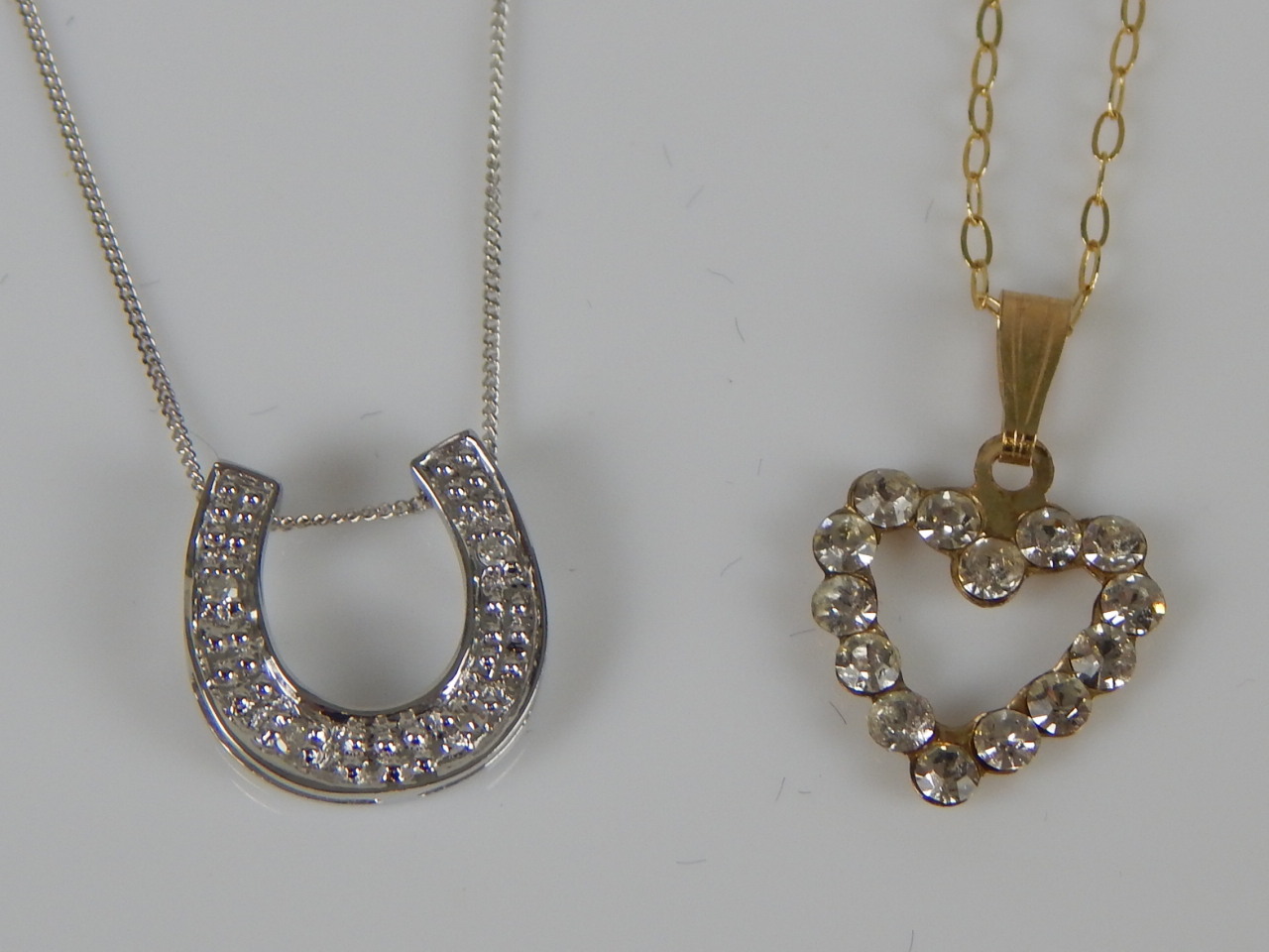 Appraisal: Two necklaces a ct white gold horseshoe pendant and chain