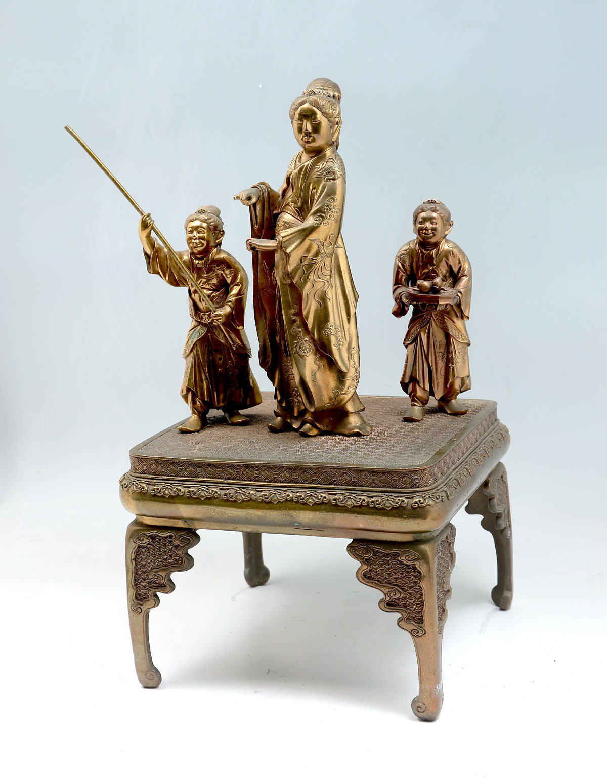 Appraisal: CHINESE BRONZE FIGURES ON STAND Chinese empress flanked by women