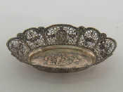 Appraisal: A cast white metal stamped basket with beaded rim and