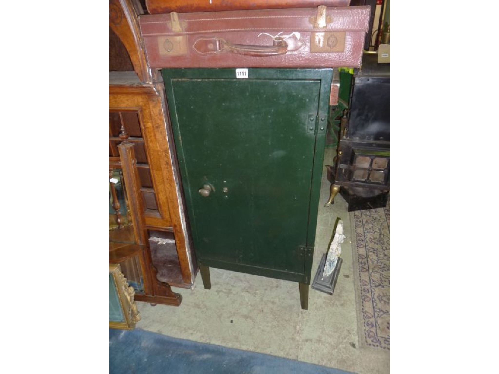 Appraisal: A vintage storage cupboard the panelled door enlosed fitted interior