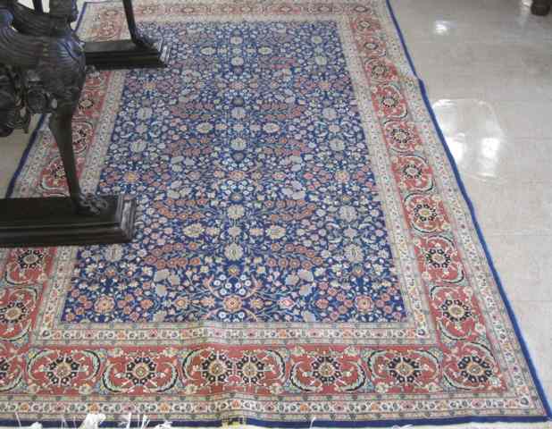 Appraisal: HAND KNOTTED ORIENTAL CARPET Pakistani-Persian overall floral decorated blue field