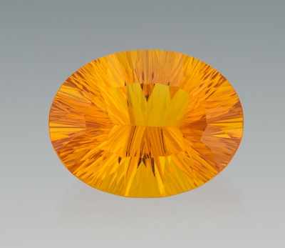 Appraisal: An Unmounted Carat Honey Citrine Concave oval cut citrine weighing