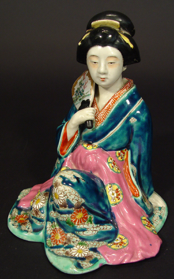 Appraisal: Japanese porcelain figurine of a crouching geisha with enamelled decoration