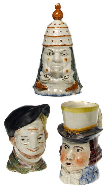 Appraisal: TWO TRANSFORMING MASK STIRRUP CUPS one of the Pope and