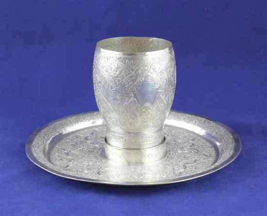 Appraisal: An Indian white metal beaker and dish with recess extensively