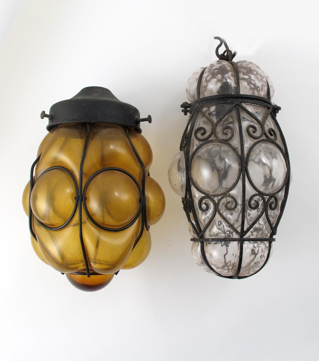 Appraisal: An amethyst glass lantern with wrought metal mount