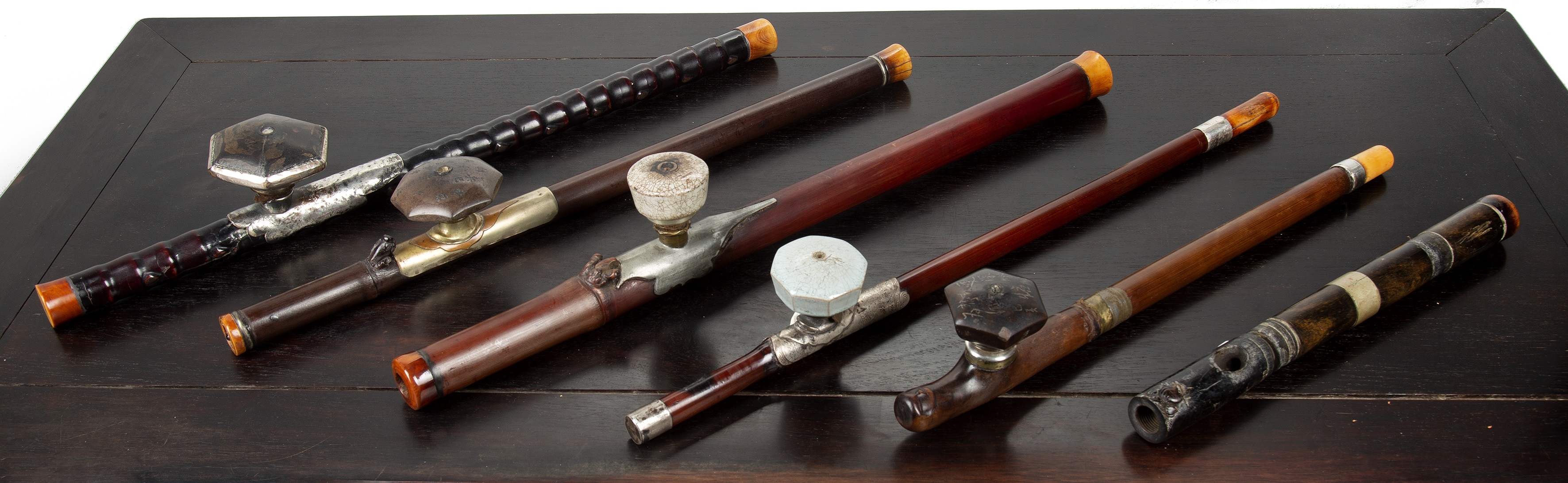 Appraisal: Six opium pipes Chinese with bamboo and wooden stems all