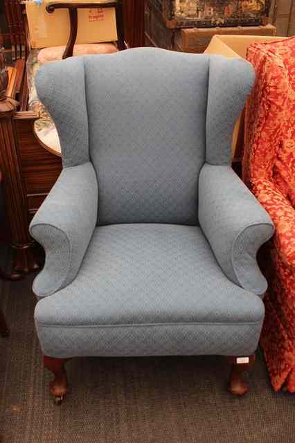 Appraisal: AN EARLY TH CENTURY BLUE UPHOLSTERED WING BACK CHAIR standing