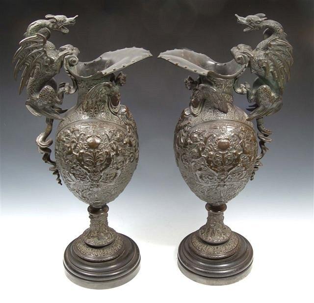 Appraisal: A pair of th Century bronze ewers with dragon handles