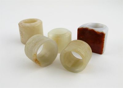 Appraisal: Five Chinese jade thumb rings one carved with shou characters