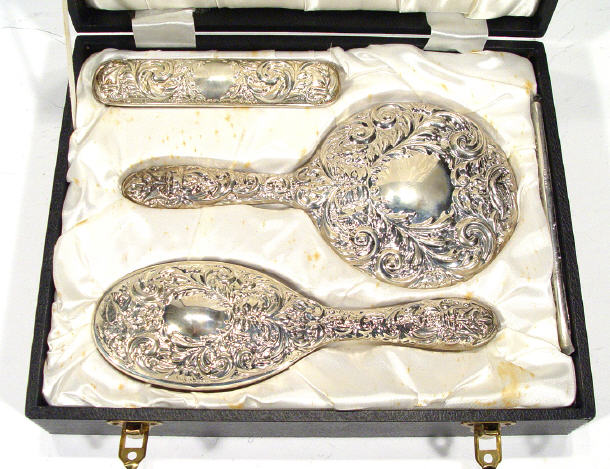 Appraisal: Modern three piece silver backed dressing table set with embossed